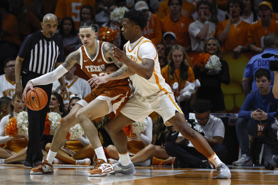 Texas forward Christian Bishop (32) works for a shot as he's defended by Tennessee forward Tobe Awaka during the first half of an NCAA college basketball game Saturday, Jan. 28, 2023, in Knoxville, Tenn. (AP Photo/Wade Payne)