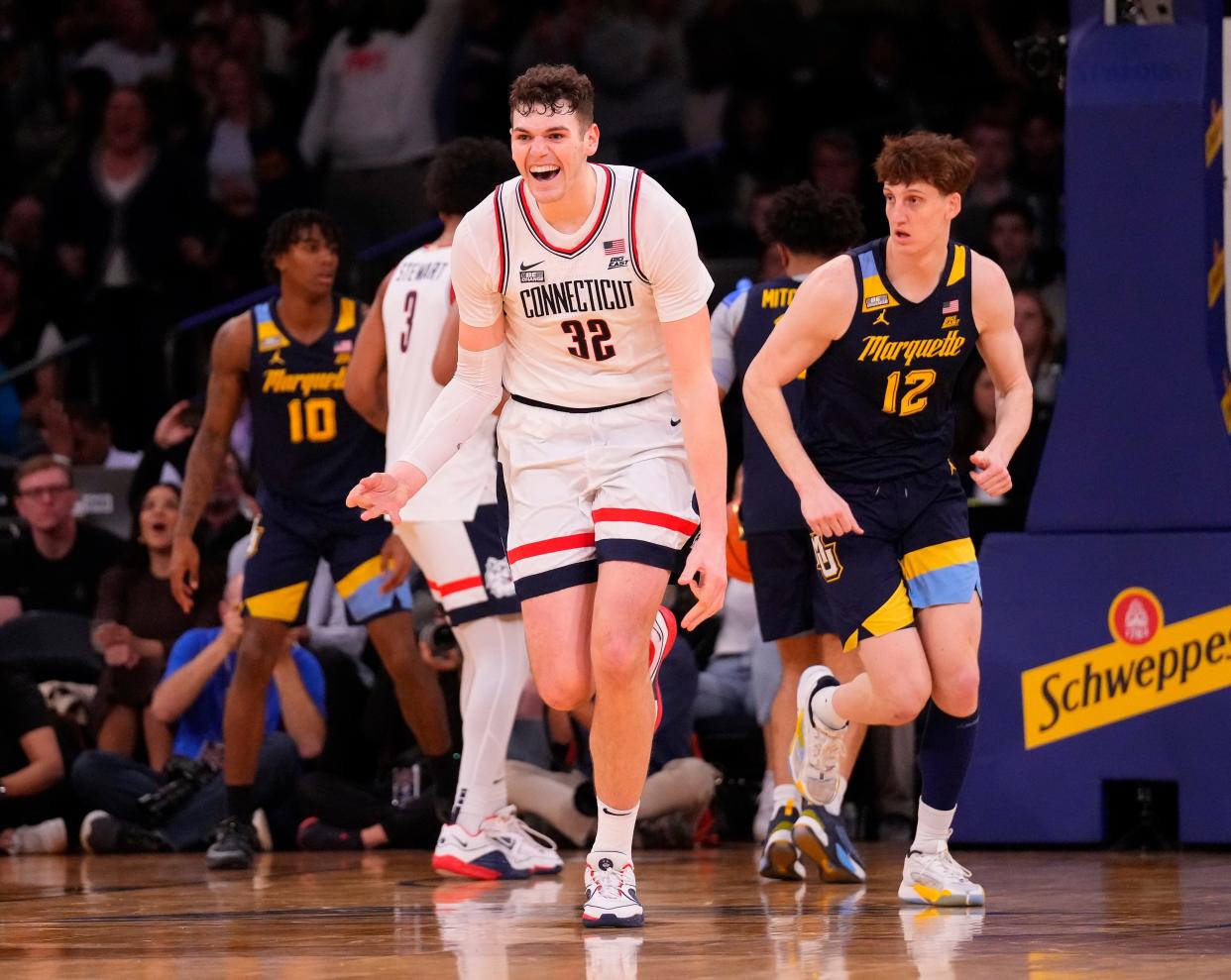 Connecticut center Donovan Clingan (32) celebrates after a big basket in the second half against Marquette in the Big East tournament championship game at Madison Square Garden.