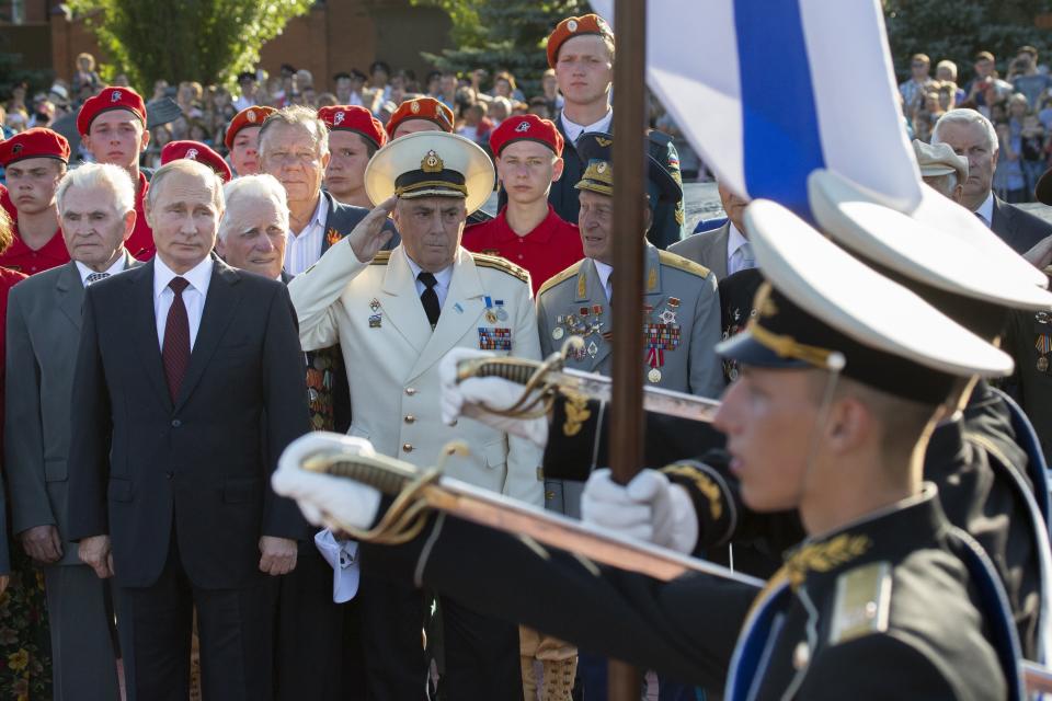 Russian President Vladimir Putin, foreground left, attends a laying ceremony in Kursk, 426 kilometers (266 miles) south of Moscow, Russia, Thursday, Aug. 23, 2018. Putin attends a ceremony marking the 75th anniversary of the battle of Kursk in which the Soviet army routed Nazi troops. It is described by historians as the largest tank battle in history involving thousands of tanks. (AP Photo/Alexander Zemlianichenko, Pool)