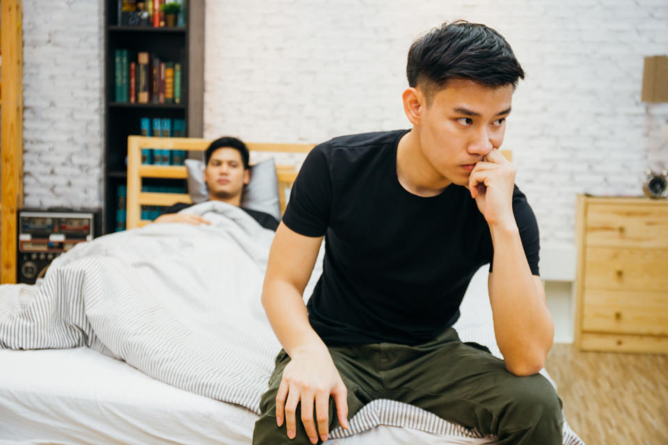 couple far apart from each other on bed