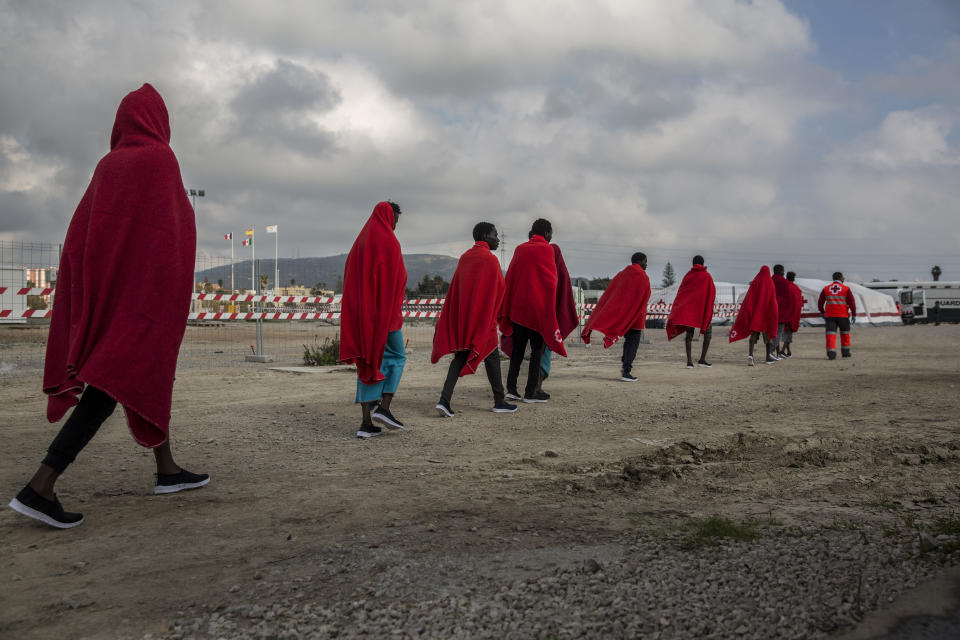 Migrants disembark from the deck of the Spanish NGO Proactiva Open Arms rescue vessel, after being rescued Dec. 21, in the Central Mediterranean Sea, before disembarking in the port of Crinavis in Algeciras, Spain, Friday, Dec. 28, 2018. The Proactiva Open Arms aid boat carrying over 300 migrants rescued at sea, has ended a weeklong journey across the western Mediterranean Sea to dock at the Spanish port of Algeciras on Friday. (AP Photo/Olmo Calvo)