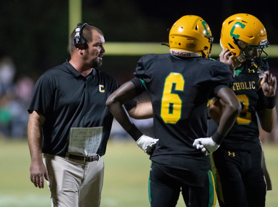 Crusaders head coach Matt Adams  talks with his players during a time out in the Tate vs Catholic varsity Kickoff Classic football game at Pensacola Catholic High School in Pensacola on Friday, Aug. 19, 2022.