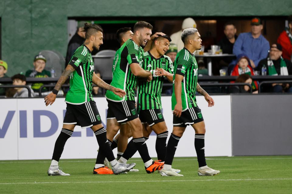 Austin FC forward Will Bruin celebrates with teammates after his goal in stoppage time that gave El Tree a 2-2 draw with the Portland Timbers on Saturday night. It salvaged a point for Austin FC.