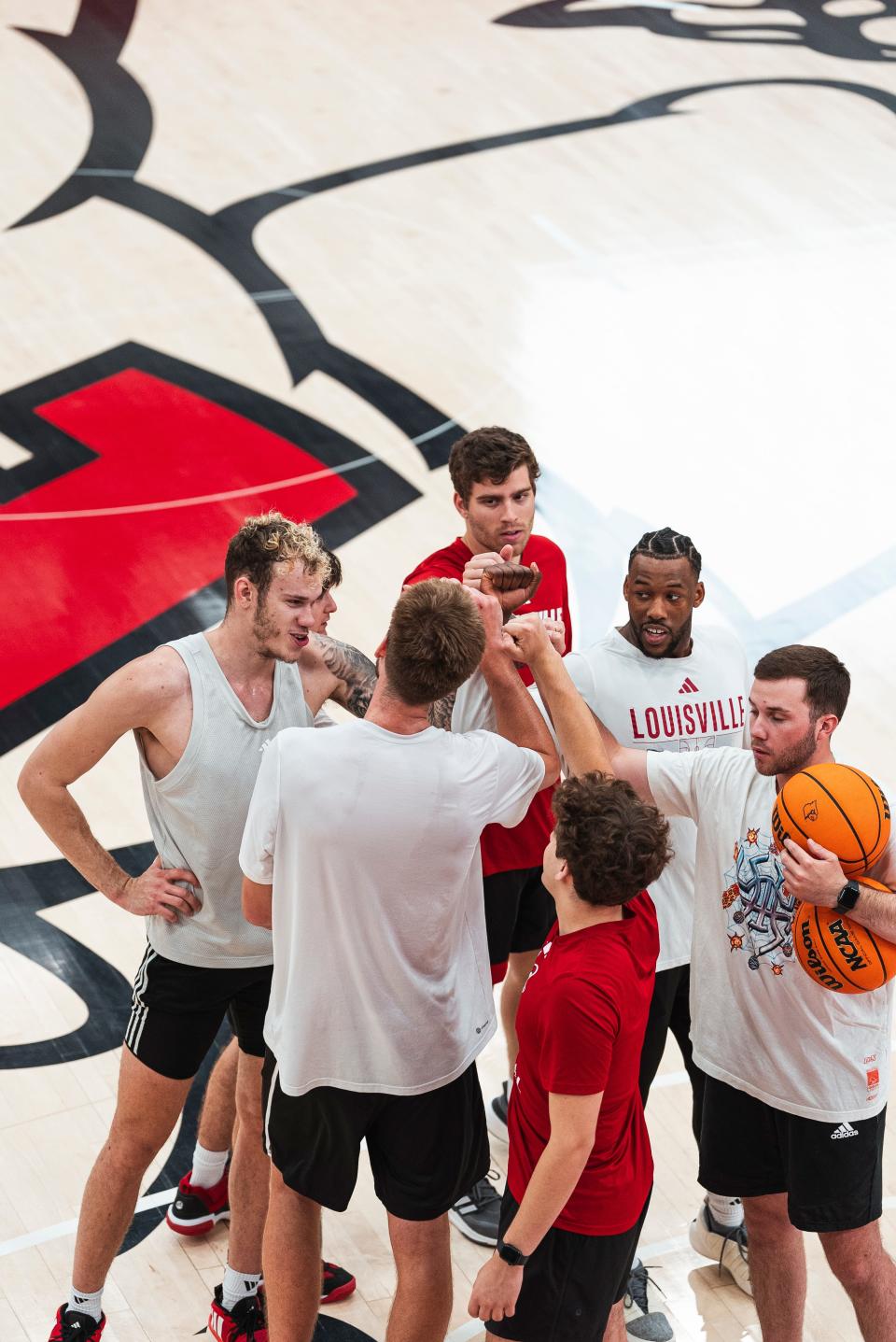 Members of the 2024-25 Louisville basketball team, players and staff, gather during a summer workout at Planet Fitness Kueber Center.  The Cardinals will play two exhibition games in the Bahamas before the first year of new head coach Pat Kelsey's tenure.