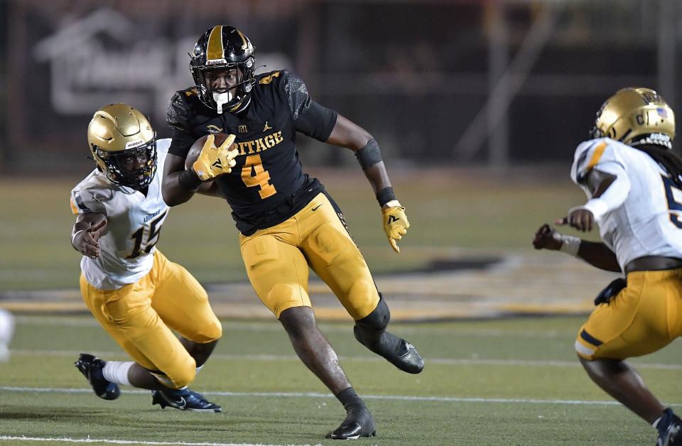 American Heritage running back Mark Fletcher runs past St. Thomas Aquinas lineman Michael Renoit during the first half of their game, Friday, September 10, 2021. Mandatory credit: Michael Laughlin, South Florida Sun Sentinel