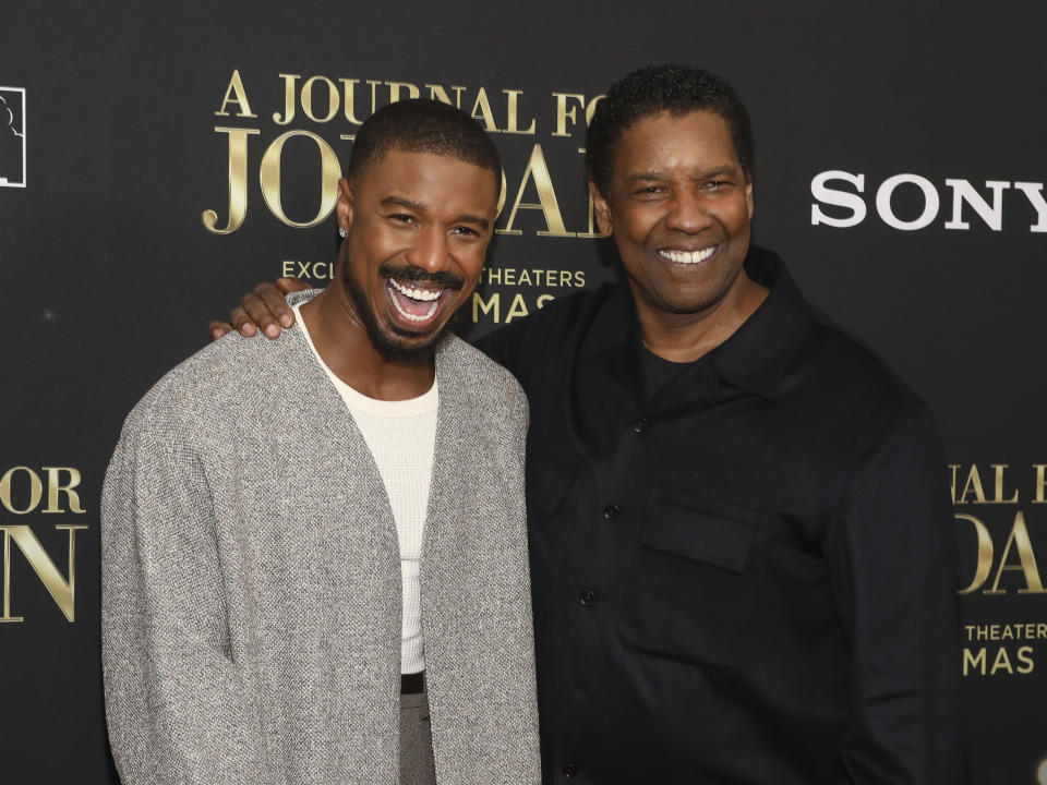 Actor Michael B. Jordan, left, and director Denzel Washington, right, attend the world premiere of "A Journal for Jordan" at AMC Lincoln Square on Thursday, Dec. 9, 2021, in New York. (Photo by Andy Kropa/Invision/AP)