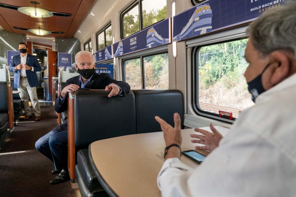 Democratic presidential candidate former Vice President Joe Biden speaks with United Steelworkers Union President Thomas Conway, right, aboard his train as it travels to Pittsburgh, Wednesday, Sept. 30, 2020. Biden is on a train tour through Ohio and Pennsylvania today. (AP Photo/Andrew Harnik)