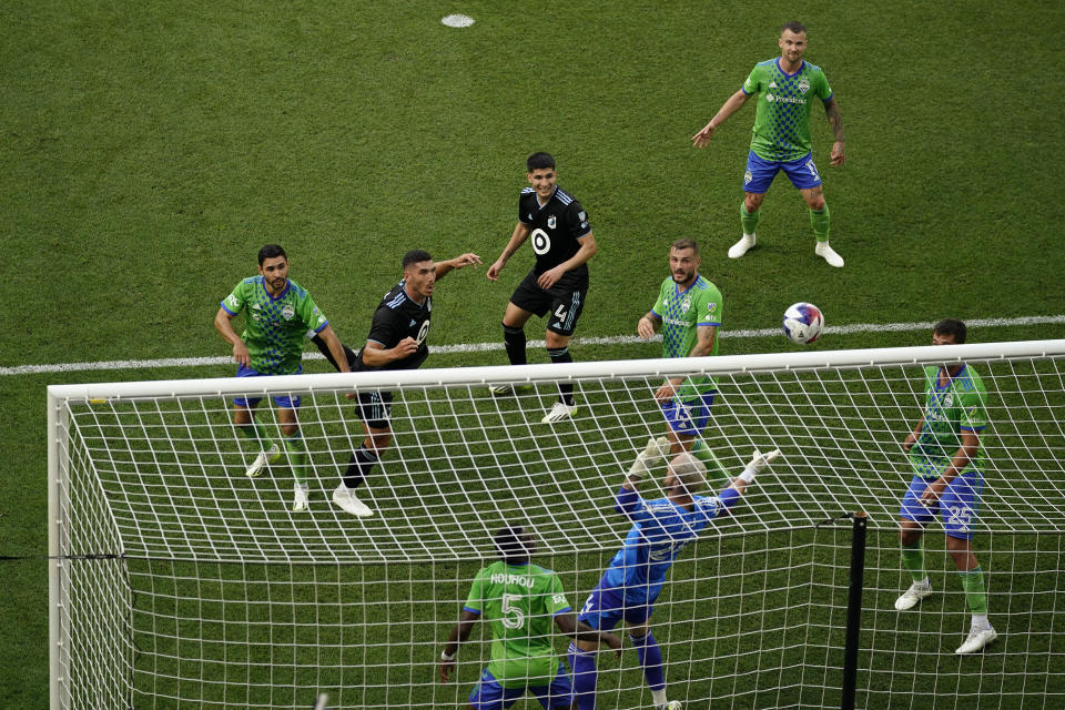 Minnesota United defender Michael Boxall, center left, misses a shot attempt during the first half of an MLS soccer match against the Seattle Sounders, Sunday, Aug. 27, 2023, in St. Paul, Minn. (AP Photo/Abbie Parr)