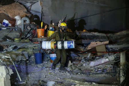 An Israeli rescue team searches for survivors in the rubble of a collapsed building after an earthquake in Mexico City, Mexico September 23, 2017. REUTERS/Henry Romero