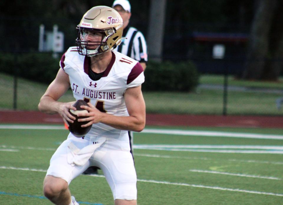 St. Augustine quarterback Locklan Hewlett (11) looks for room to throw against Bolles during Friday's come-from-behind win.