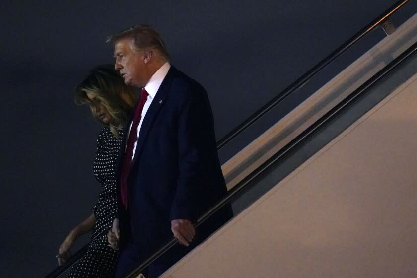 President Donald Trump and first lady Melania Trump step off Air Force One at Palm Beach International Airport, Wednesday, Dec. 23, 2020, in Palm Beach, Fla. Trump is visiting his Mar-a-Lago resort. (AP Photo/Patrick Semansky)