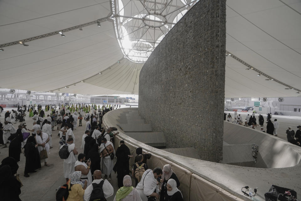 Pilgrims cast stones at a pillar in the symbolic stoning of the devil, the last rite of the annual Hajj pilgrimage, in Mina near the holly city of Mecca, Saudi Arabia, Wednesday, June 28, 2023. (AP Photo/Amr Nabil)