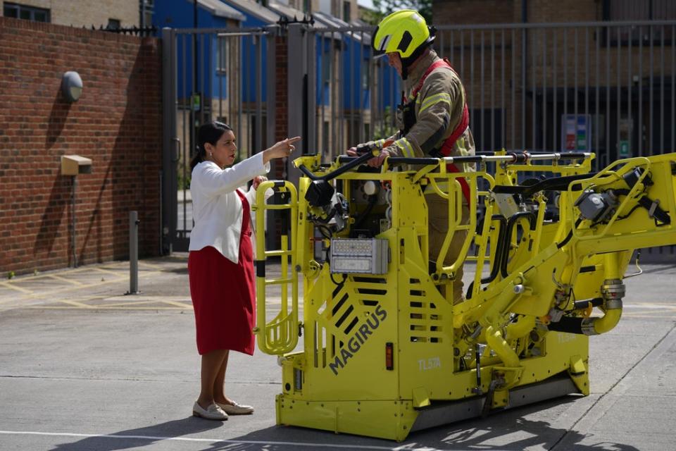 Home Secretary Priti Patel speaks to firefighter during a visit to Old Kent Road Fire Station, Southwark, south east London on Wednesday (Yui Mok/PA) (PA Wire)