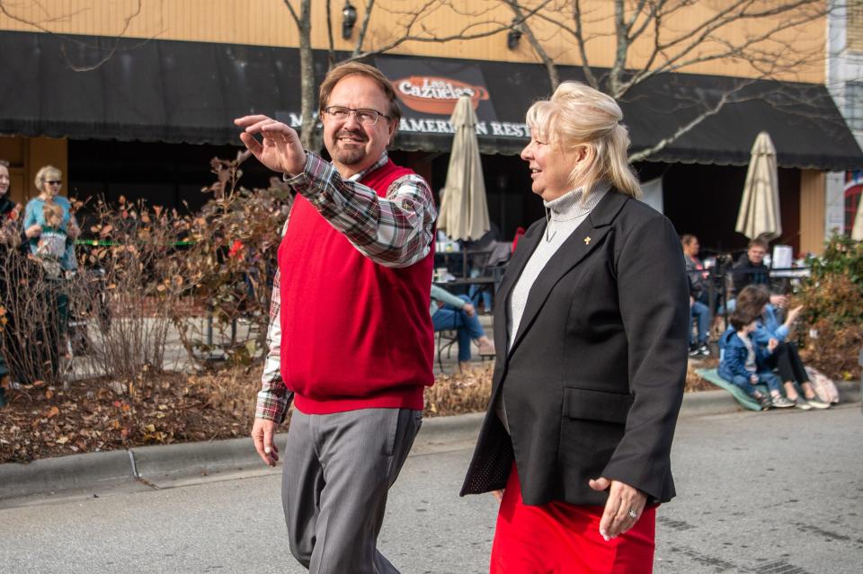 State Sen. Chuck Edwards and his wife, Teresa, walk in the Hendersonville Christmas parade on December 4, 2021.