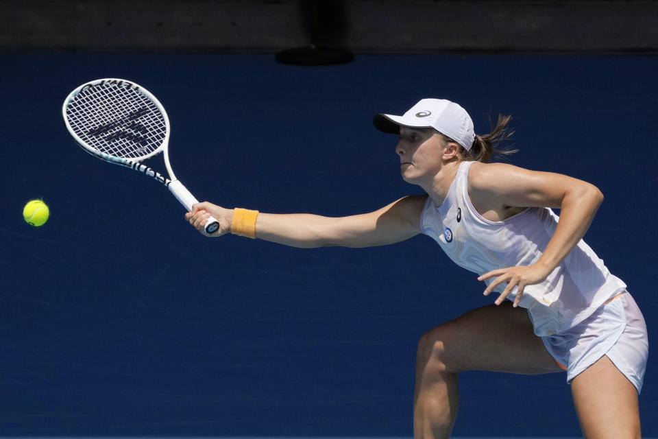 Iga Swiatek of Poland plays a forehand return to Elena Rybakina of Kazakhstan during their fourth round match at the Australian Open tennis championship in Melbourne, Australia, Sunday, Jan. 22, 2023. (AP Photo/Aaron Favila)