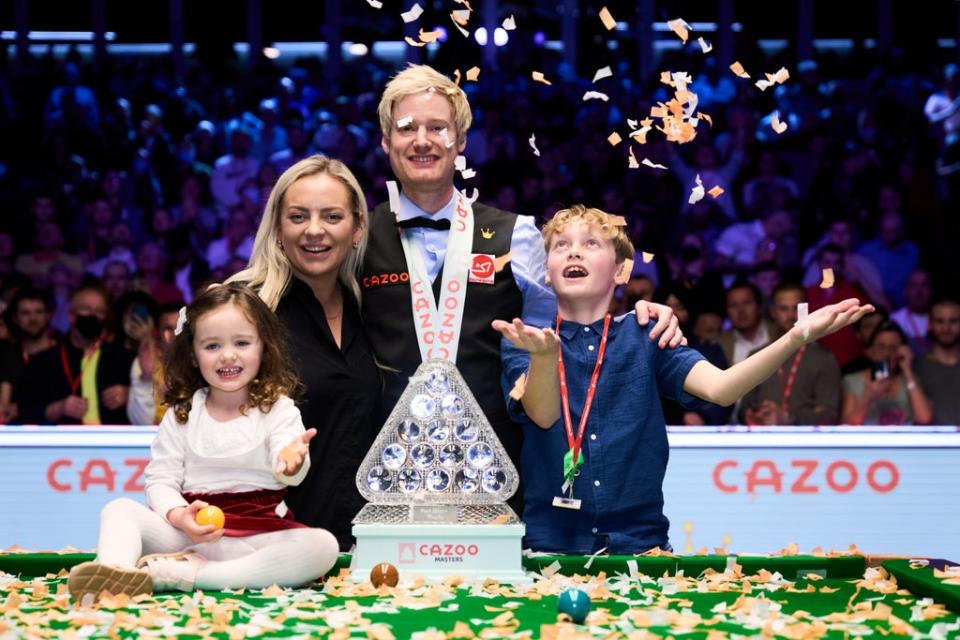 Neil Robertson celebrates his Masters triumph at Alexandra Palace alongside his wife Mille, daughter Penelope and son Alexander (John Walton/PA) (PA Wire)