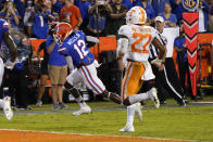 Florida wide receiver Rick Wells (12) runs past Tennessee defensive back Jaylen McCollough (22) on his way to a touchdown off a 9-yard pass play during the second half of an NCAA college football game, Saturday, Sept. 25, 2021, in Gainesville, Fla. (AP Photo/John Raoux)