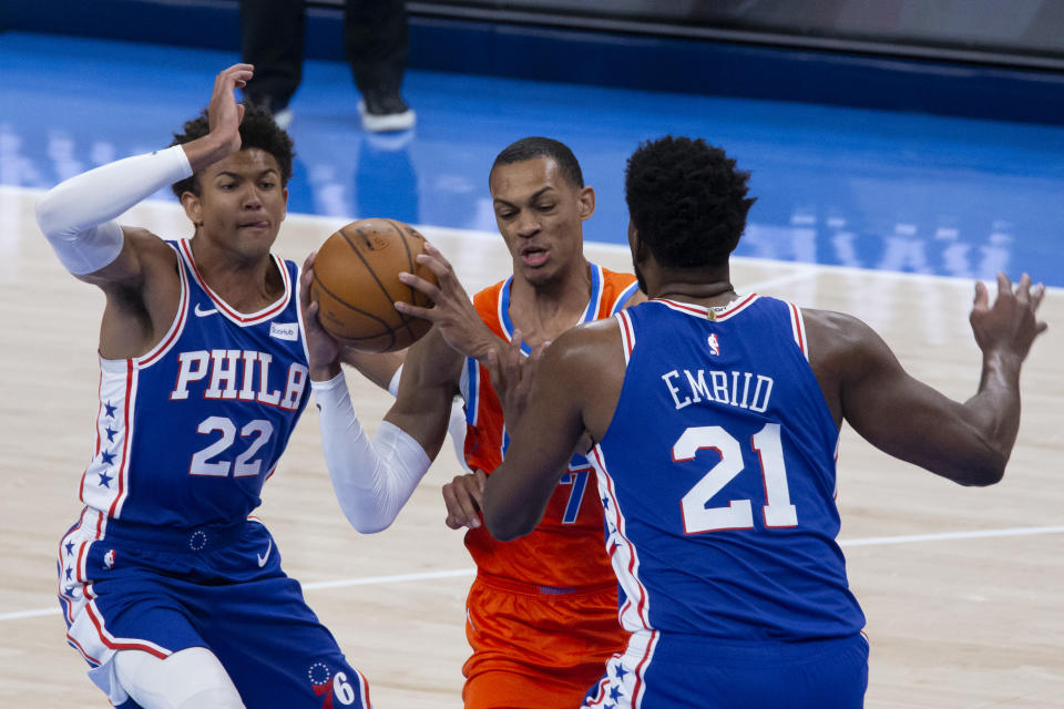 Oklahoma City Thunder forward Darius Bazley (7) goes against Philadelphia 76ers centers Joel Embiid (21) and Joel Embiid (21) during the first half of an NBA basketball game, Saturday, April 10, 2021, in Oklahoma City. (AP Photo/Garett Fisbeck)