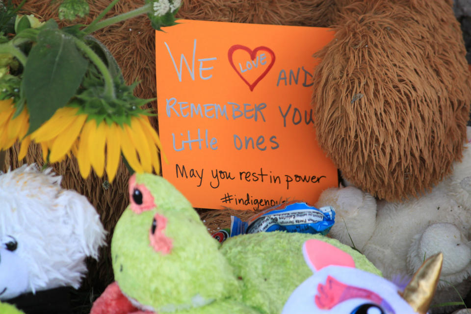 A makeshift memorial for the dozens of Indigenous children who died more than a century ago while attending a boarding school that was once located nearby is growing under a tree at a public park in Albuquerque, N.M., Thursday, July 1, 2021. Indigenous activists are concerned that a plaque that noted the site of the burial ground was removed in recent days. (AP Photo/Susan Montoya Bryan)