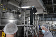 Rabbi Mendel Einhorn, top, talks with employees at Hanan Products while he supervises the koshering for their kosher-for-passover production run, Thursday, Jan. 7, 2021, in Hicksville, N.Y. The springtime holiday celebrates the Jewish people’s liberation from slavery, when, as described in the Old Testament, they did not have time even to let bread leaven before rushing into the desert during their flight from Egypt. (AP Photo/Seth Wenig)
