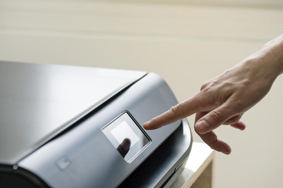 Close up of female hand using computer printer