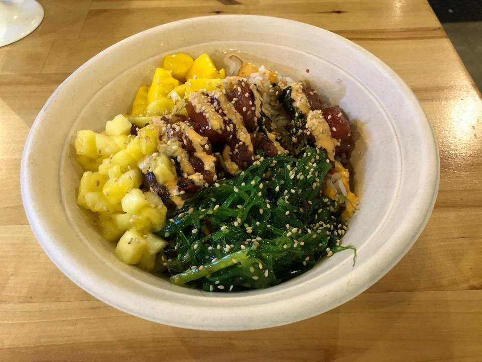 An "Onolicious" poke bowl from Poke Papa, including ahi, seaweed salad, pineapple and mango.