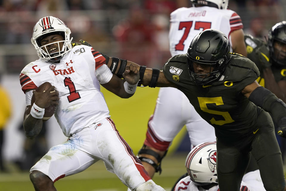 Utah quarterback Tyler Huntley (1) is sacked by Oregon defensive end Kayvon Thibodeaux (5) during the second half of an NCAA college football game for the Pac-12 Conference championship in Santa Clara, Calif., Friday, Dec. 6, 2018. Oregon won 37-15. (AP Photo/Tony Avelar)