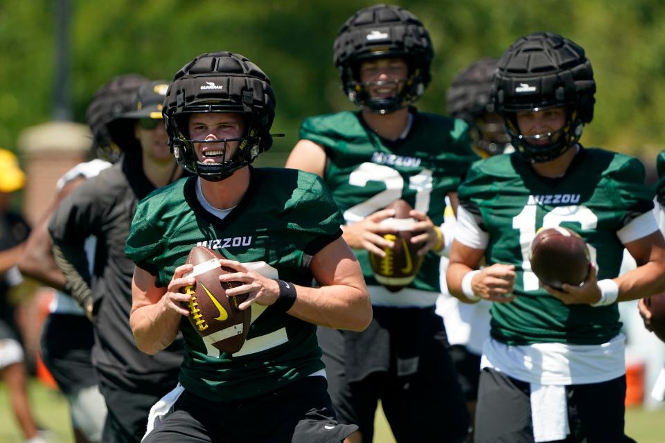 Missouri quarterback Brady Cook, front left, takes part in a drill during practice Aug. 10.