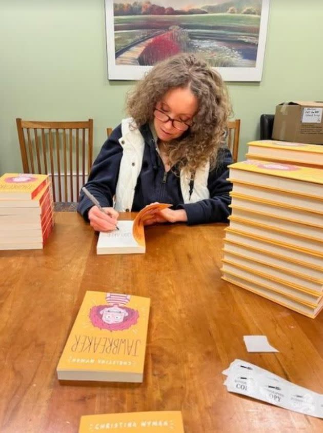 The author signing copies of her debut Middle Grade novel, 