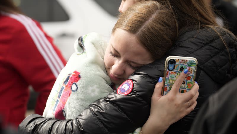 Two women hug when reunited following a shooting at East High School, Wednesday, March 22, 2023, in Denver.