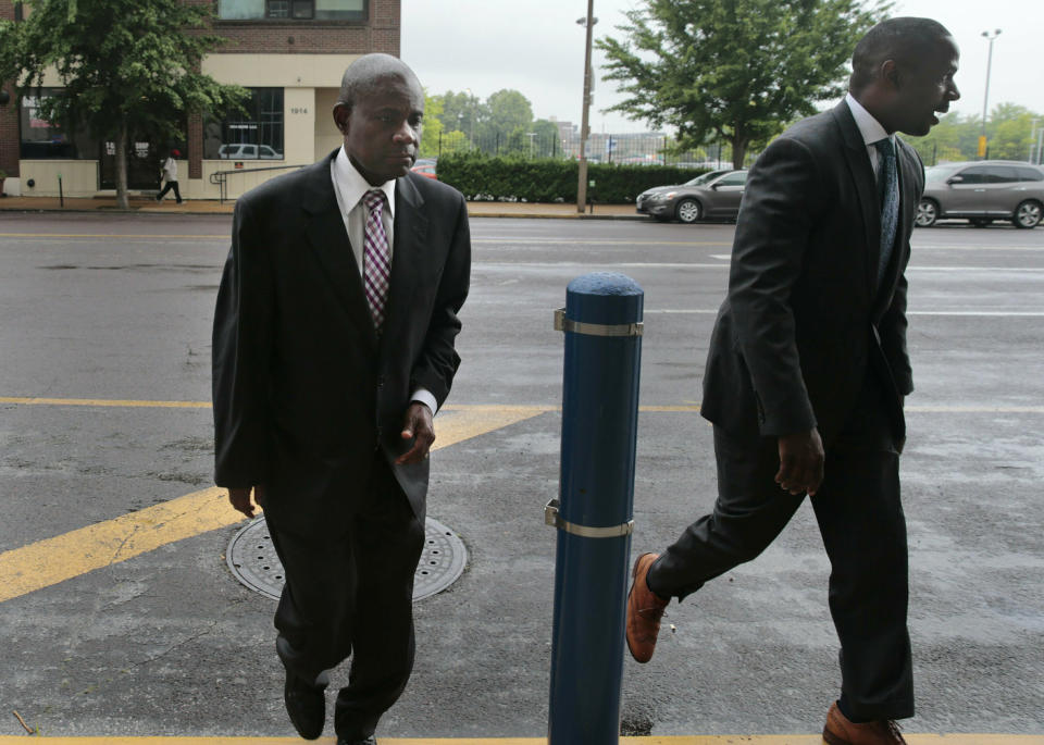 FILE - In this June 17, 2019 file photo, former FBI agent William Don Tisaby, left, is accompanied by attorney Jermaine Wooten, in St Louis. A St. Louis judge said Thursday, June 24, 2021, that he'll decide by the end of next week whether to allow the special prosecutor to withdraw from the perjury and evidence tampering case against Tisaby, a former FBI agent hired by St. Louis' top prosecutor to investigate former Gov. Eric Greitens. Tisaby, 68, was indicted in 2019. (Robert Cohen/St. Louis Post-Dispatch via AP, File)