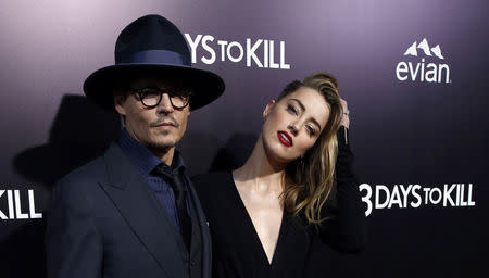 Amber Heard and her fiance Johnny Depp pose at the premiere of "3 Days to Kill" in Los Angeles. REUTERS/Mario Anzuoni