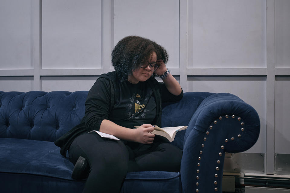 Gionna Durham, 13, reads a book on the sofa on Saturday, Jan. 27, 2024, in New York. With the damaging consequences of social media increasingly well documented, many parents are trying to raise their children with restrictions or blanket bans. Teenagers themselves are aware that too much social media is bad for them, and some are initiating social media “cleanses” because of the toll it takes on mental health and grades. (AP Photo/Andres Kudacki)