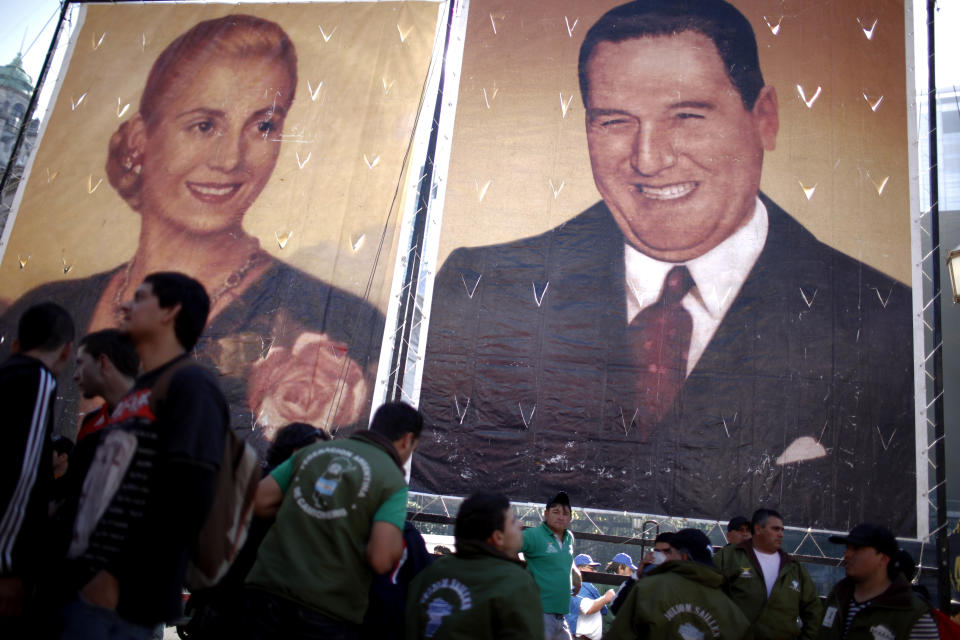 Protesters stand by posters of Argentina's late strongman Juan Peron and his wife Evita Peron at Plaza de Mayo in Buenos Aires, Argentina, Wednesday, June 27, 2012. The strike and demonstration called by union leader Hugo Moyano demands steps that would effectively reduce taxes on low-income people, among other measures. (AP Photo/Natacha Pisarenko)