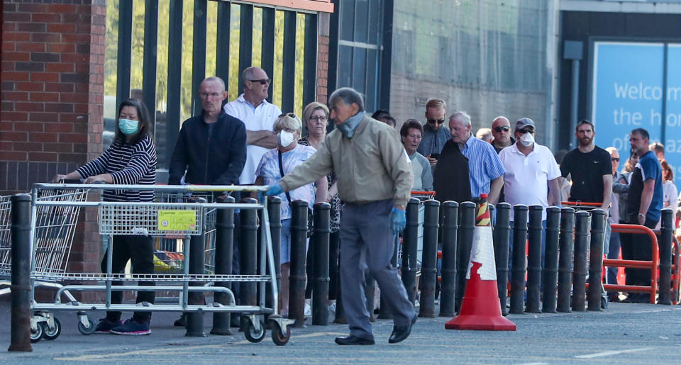 People queue outside a B&Q in Wallasey, Wirral. as the UK continues in lockdown to help curb the spread of the coronavirus.