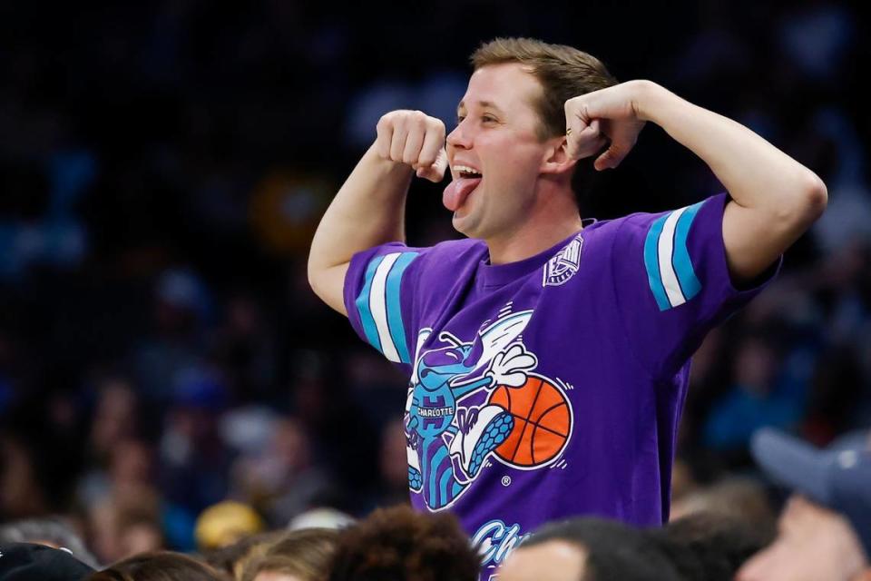 A Charlotte fan celebrates in the stands during a game against the Dallas Mavericks at Spectrum Center in Charlotte, N.C., Saturday, March 19, 2022.
