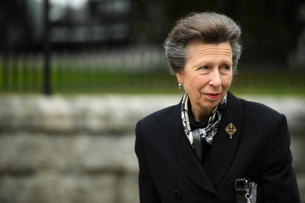 Britain's Princess Anne, Princess Royal looks at the flowers placed outside Balmoral Castle in Ballater, on September 10, 2022, two days after Queen Elizabeth II died at the age of 96. - King Charles III pledged to follow his mother's example of 