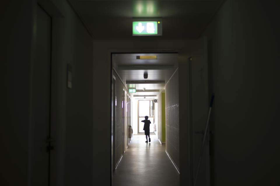 A boy walks down the hall of shelter for temporary accommodation for new asylum seekers near the central registration in Berlin, Germany, Monday, Sept. 25, 2023. Across Germany, officials are sounding the alarm that they are no longer in a position to accommodate migrants who are applying for asylum. (AP Photo/Markus Schreiber)