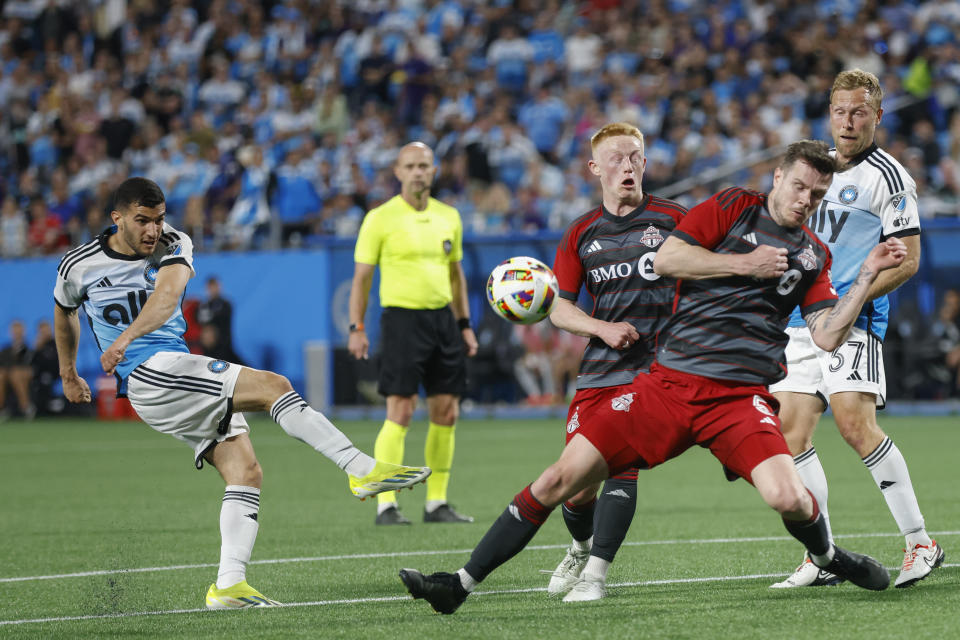 Charlotte FC forward Liel Abada, left, shoots against Toronto FC midfielder Matty Longstaff, second from right, and defender Kevin Long, right, during the first half of an MLS soccer match in Charlotte, N.C., Saturday, April 13, 2024. (AP Photo/Nell Redmond)