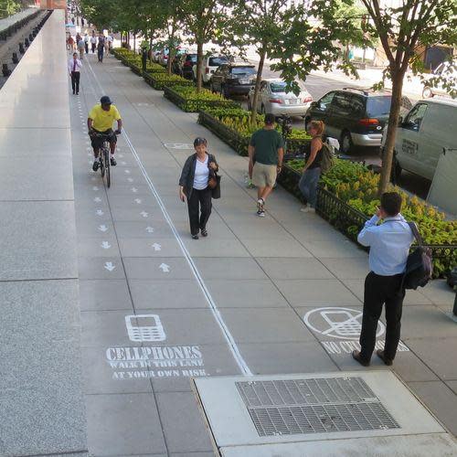 Pedestrians and a cyclist using the lanes