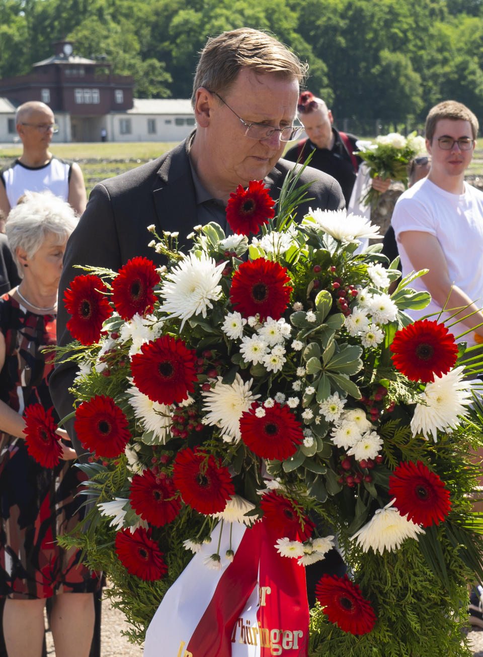 Bodo Ramelow, governor of German state Thuringia, lays a wreath in remembrance for prisoners assigned a pink triangle in the former Nazi concentration camp Buchenwald within the Christopher Street Day in Weimar, Germany, Sunday, June 23, 2019. There were 650 prisoners assigned a pink triangle in the Buchenwald concentration camp between 1937 and 1945. Many of them lost their lives. (AP Photo/Jens Meyer)