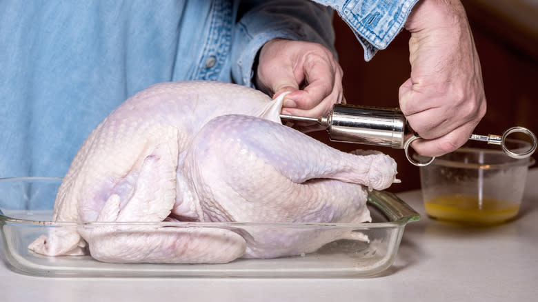 Injecting marinade into raw turkey