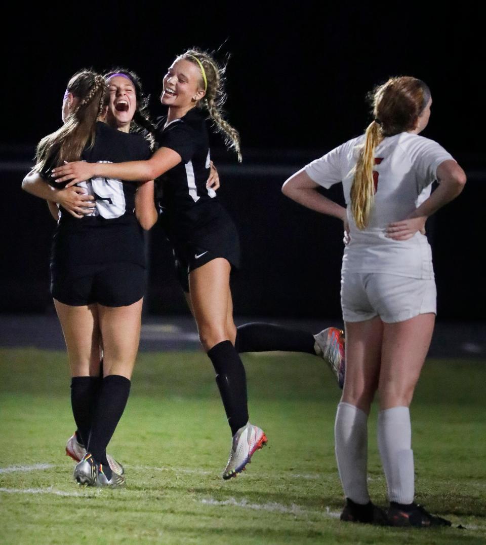 Kelsi Longabardi, left, and Ryleigh Acosta congratulate teammate Carly Paz, center, after she scored the third goal of the game against North Fort Myers as North Fort Myers player Carolina Jenkins stands by on the far right. The Mariner High School girls soccer team defeated North Fort Myers 3-0 at home on Feb. 14, 2023, winning the Class 5A regional championship. 