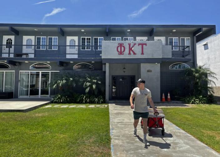 Los Angeles, CA - August 12, 2022 - Isaac Ignatius, president of Phi Kappa Tau, moves his belongings from one fraternity home to his new home on 