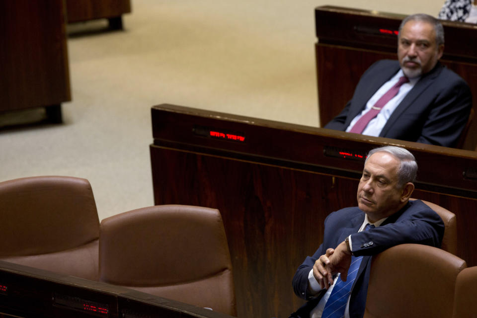 FILE - In this May 23, 2016 file photo, Israeli Prime Minister Benjamin Netanyahu and former Israeli Defense Minister Avigdor Lieberman sit in the Knesset, Israel's parliament, in Jerusalem. Netanyahu is facing the possibility of having to fight a second election this year, as he struggles to form a coalition government. With a looming deadline, Israel's newly elected parliament began drafting a bill on Monday to dissolve itself. (AP Photo/Sebastian Scheiner, File)