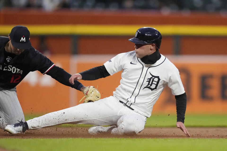 Detroit Tigers designated hitter Kerry Carpenter is tagged out by Minnesota Twins third baseman Kyle Farmer during the first inning of a baseball game, Friday, April 12, 2024, in Detroit. (AP Photo/Carlos Osorio)