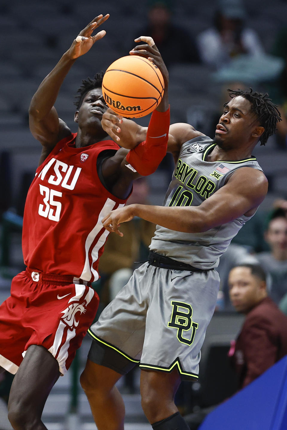 Washington State forward Mouhamed Gueye (35) and Baylor guard Adam Flagler (10) battle for the ball during the first half of an NCAA college basketball game on Sunday, Dec. 18, 2022, in Dallas. (AP Photo/Brandon Wade)