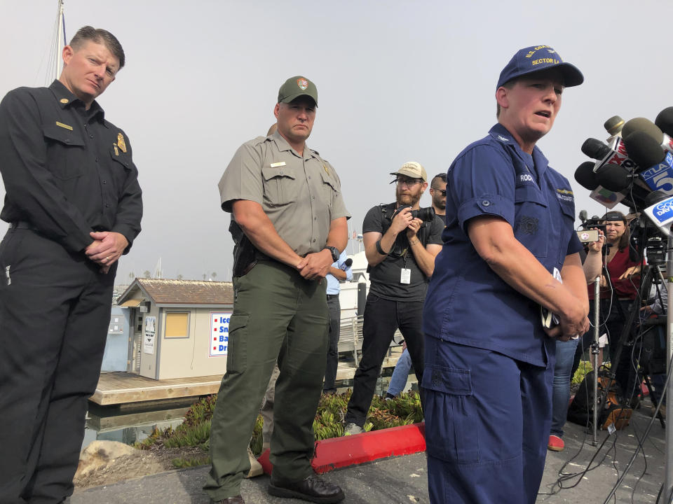 Coast Guard Capt. Monica Rochester, right, addresses the media at the U.S. Coast Guard Station Channel Islands base in Oxnard, Calif. Monday, Sept. 2, 2019. A dive boat caught fire before dawn Monday off the Southern California coast. Several crew members were rescued and Lt. Cmdr. Matthew Kroll told The Associated Press the Coast Guard was searching for others who may have been able to escape the fire by jumping from the boat. (AP Photo/Stefanie Dazio)