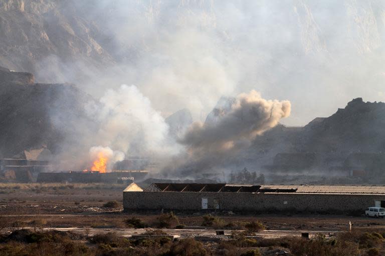 Smoke billows from the site of an explosion that hit an arms depot in Aden, Yemen, March 28, 2015