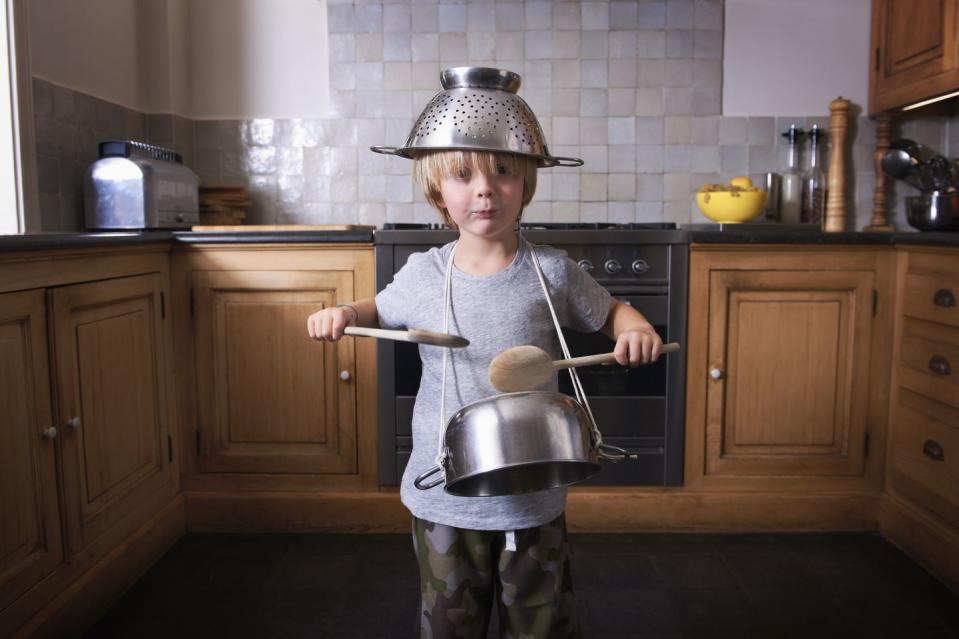 boy playing the drums on a pan with spatulas fun activities for kids